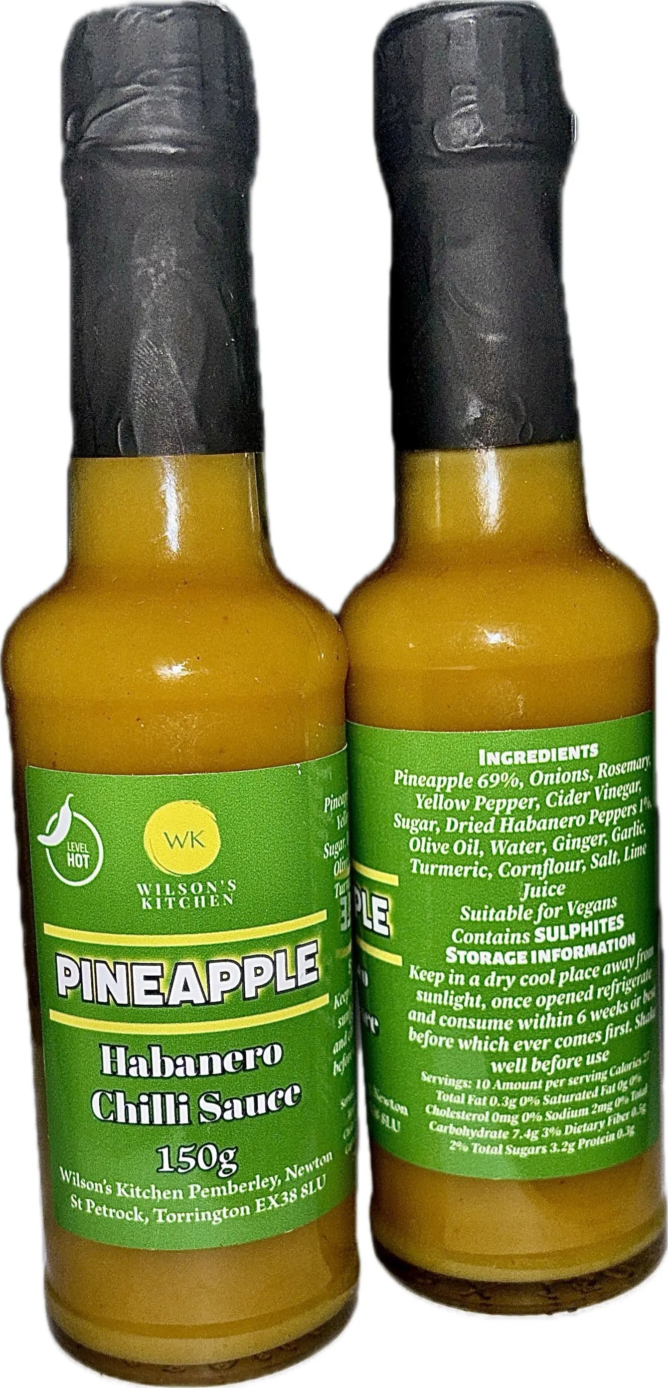 Wilson’s Kitchen Pineapple Habanero Sauce in a glass bottle, vibrant orange color, with fresh pineapple and habanero peppers visible