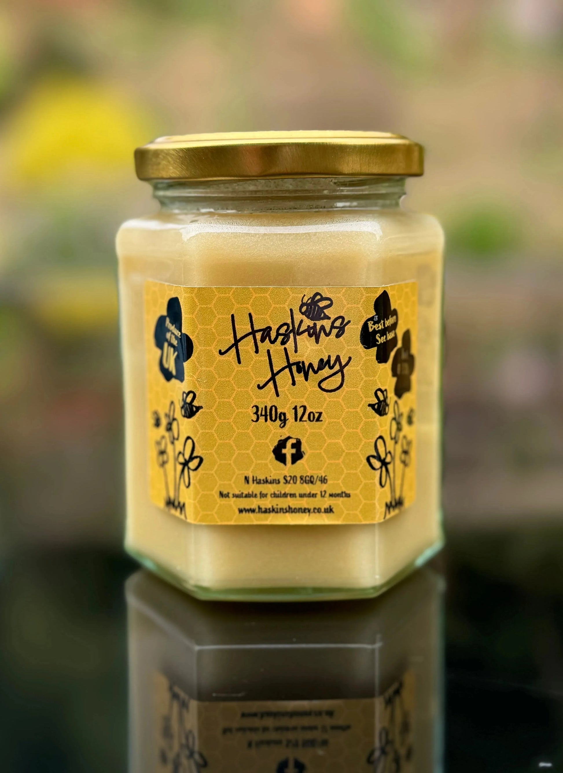 Jar of Meadow Cream honey by Haskins Honey with a golden, smooth honey surface in a clear glass jar.