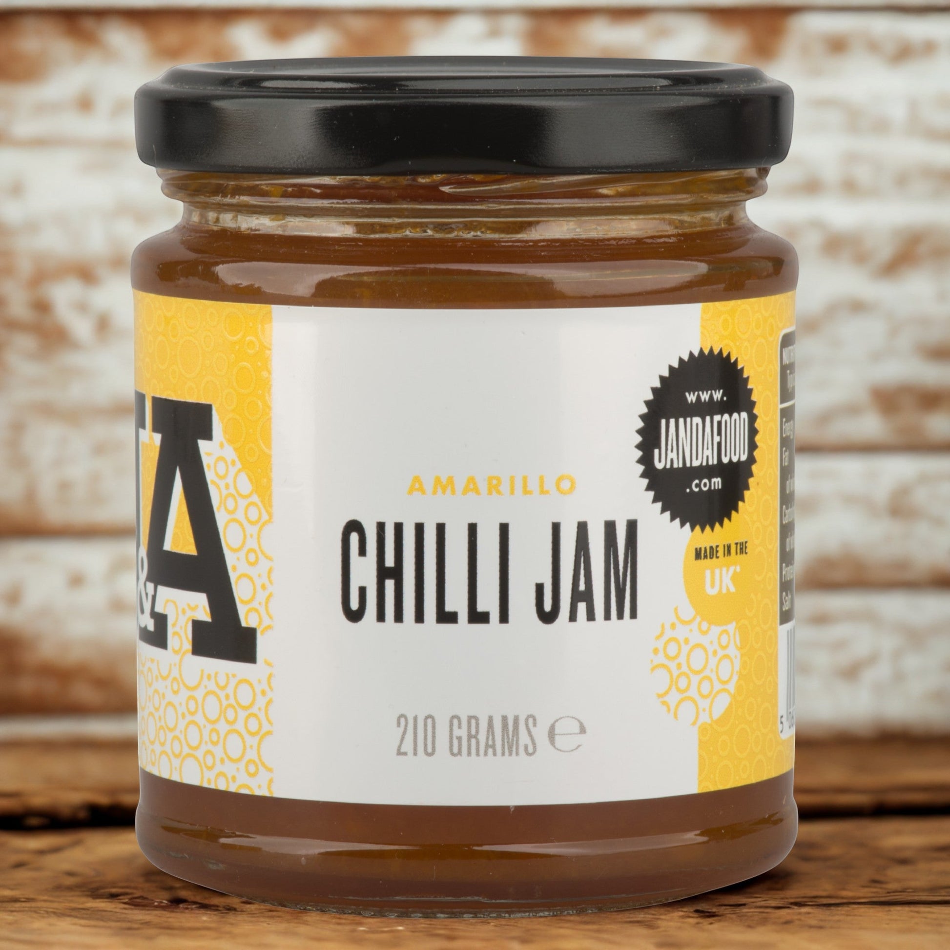 Janda Amarillo Yellow Chilli Jam 210g jar with bright yellow chili jam, showcasing its sweet and spicy flavor for cheese and barbecue dishes.