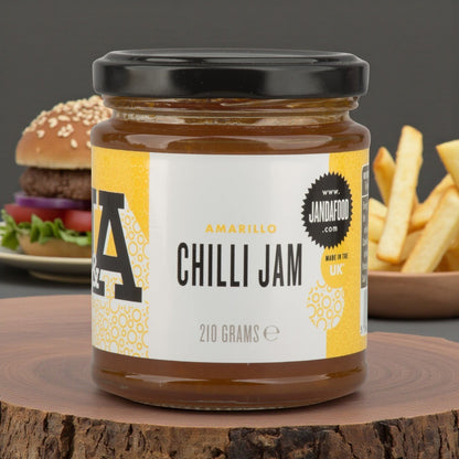 Janda Amarillo Yellow Chilli Jam 210g jar showing vibrant yellow chili spread with a spoon, perfect for cheese and barbecue dishes.