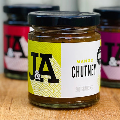 Janda Chutney and Relish Trio Gift Box with jars of mango chutney and assorted relishes on a neutral background.
