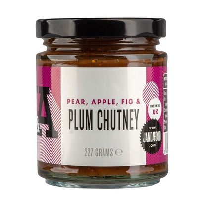 Janda Pear, Apple, Fig & Plum Chutney jar with fresh fruit ingredients displayed next to the jar.