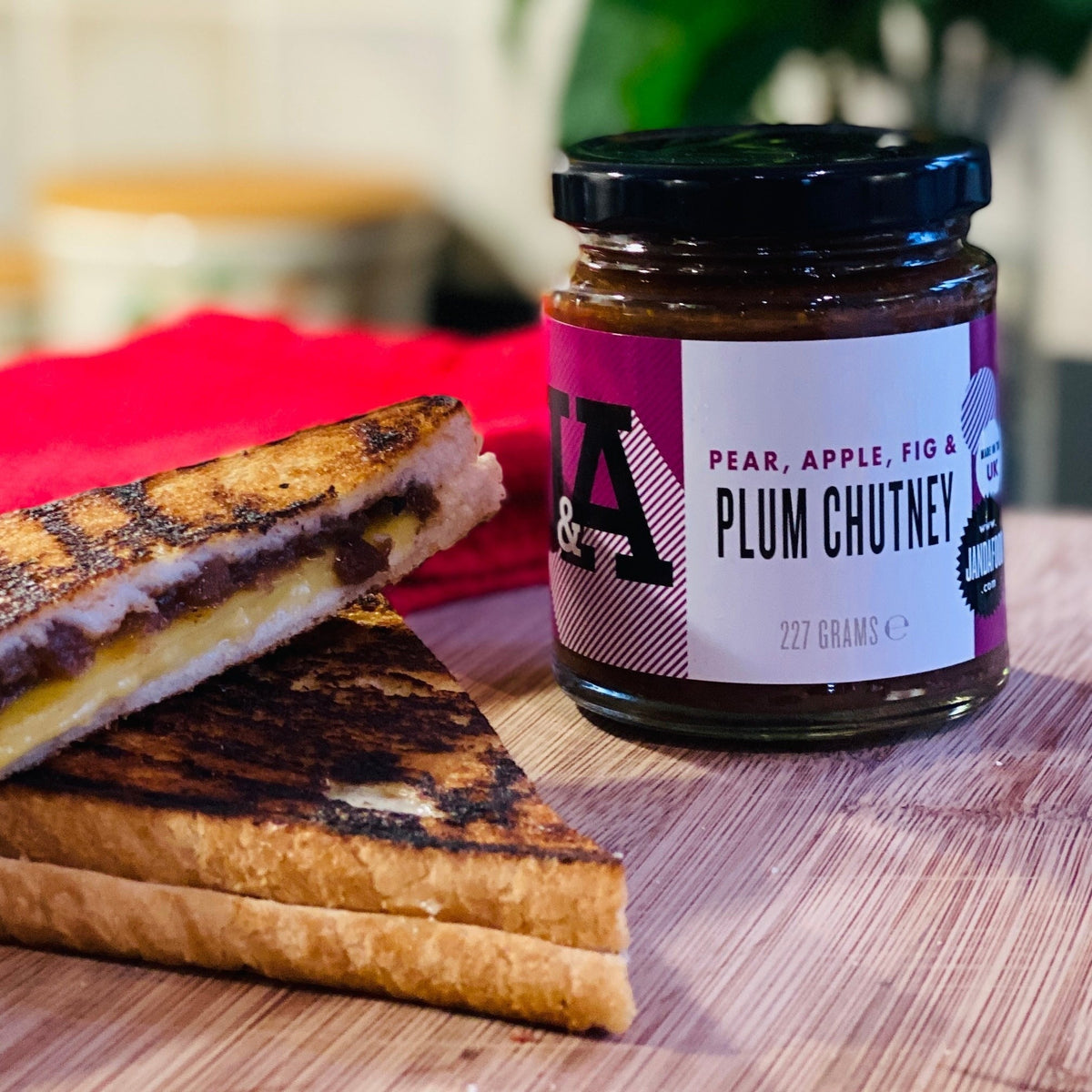 Jar of Janda Pear, Apple, Fig & Plum Chutney with visible fresh fruit pieces and rich, textured chutney inside.
