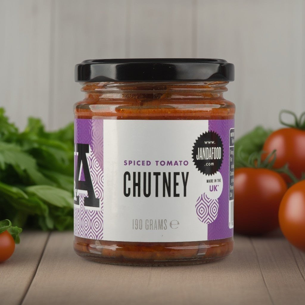Jar of Janda Spiced Tomato Chutney with a rich, vibrant red color and fresh herbs visible on the label.