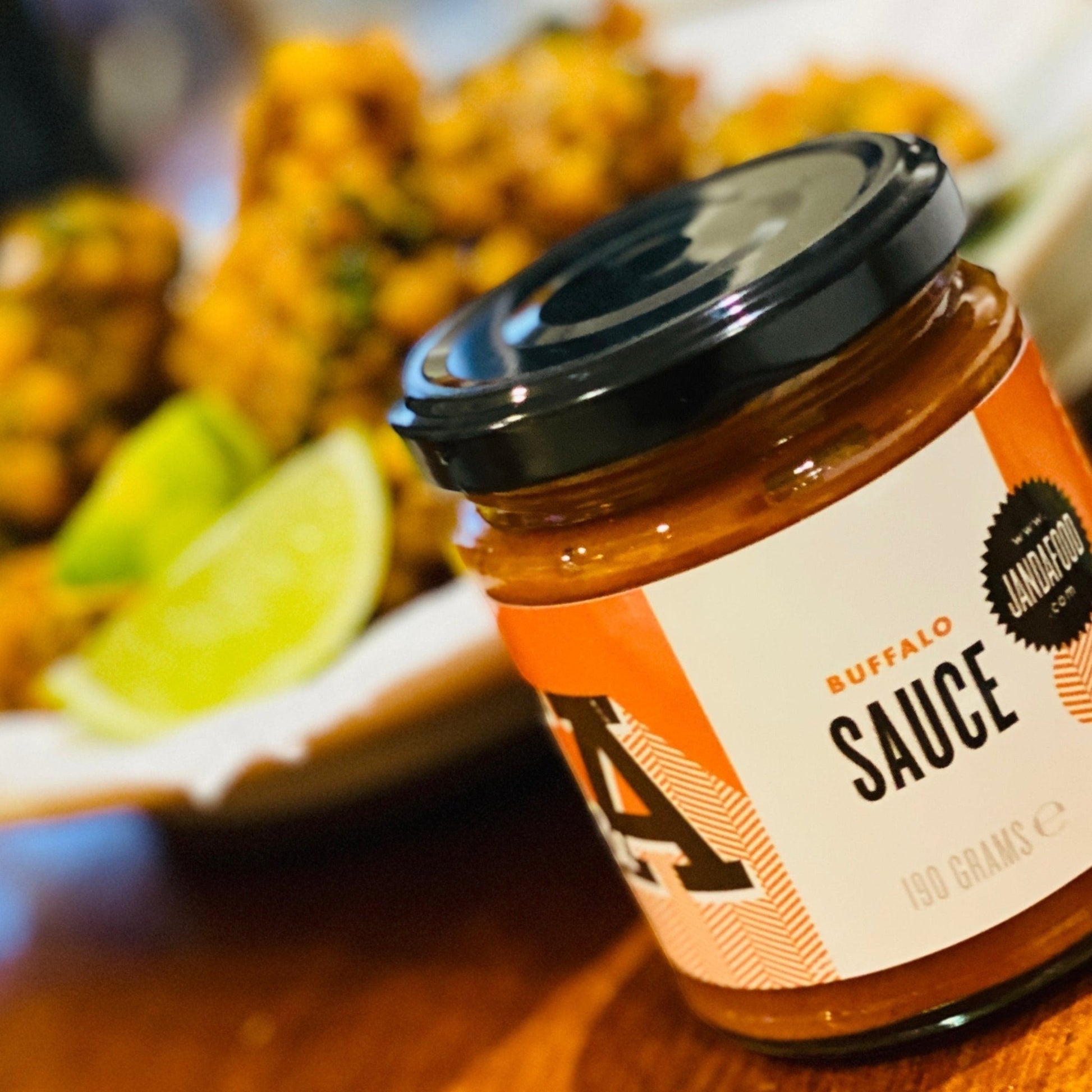 Janda Food vegan buffalo sauce bottle with label, showcasing spicy buffalo sauce for chicken or snacks.