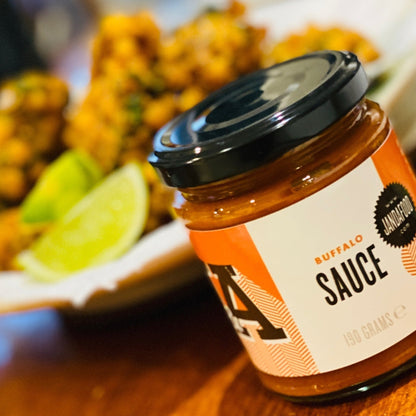 Janda Food vegan buffalo sauce bottle with label, showcasing spicy buffalo sauce for chicken or snacks.