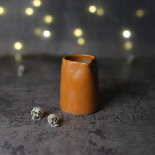 Mini ceramic jug featuring a mandarin orange design by Katie L Thompson Designs, perfect for decor or serving small amounts.