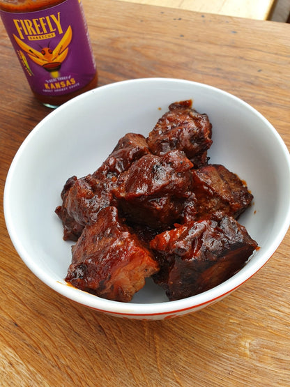 Burnt-orange Kansas Brisket BBQ Sauce bottle by FireFly Barbecue, with label featuring smoky barbecue sauce and branding.