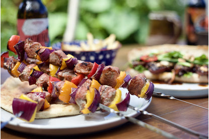 Diced Primrose Herd pork pieces ideal for kebabs, showing evenly cut cubes of raw pork meat on skewers.