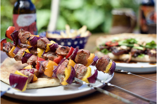 Diced Primrose Herd pork pieces ideal for kebabs, showing evenly cut cubes of raw pork meat on skewers.