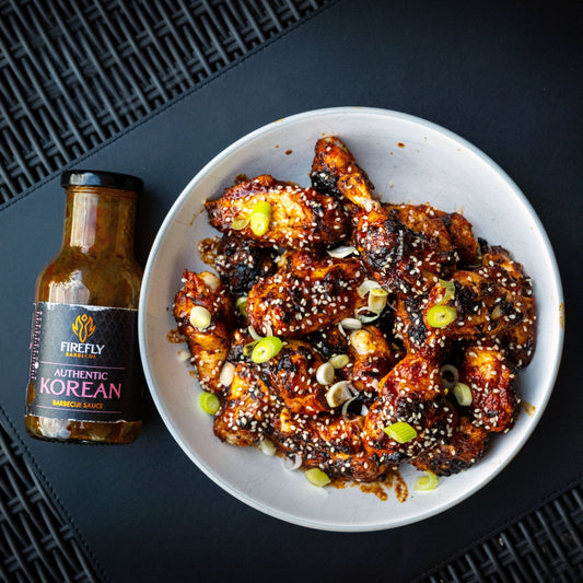FireFly Barbecue Korean BBQ sauce glazed chicken wings on a plate, showcasing the glossy, flavorful Korean-inspired sauce.