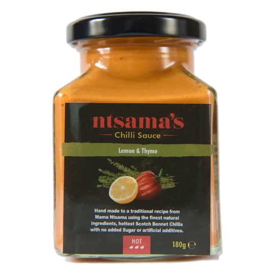 Lemon and thyme sauce jar from ntsama.co.uk showing a glass bottle with fresh lemon slices and thyme sprigs.