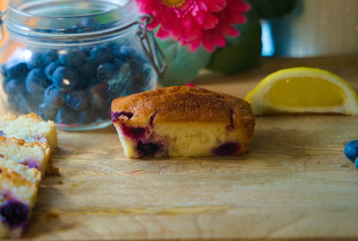 Lemon and blueberry free from cake from The Healthy Cake Company, showing slices with lemon and blueberry decorations.