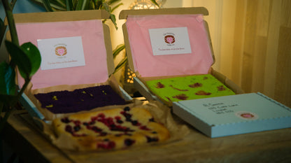 Letter box cake from The Healthy Cake Company, decorated with colorful icing and festive toppings.