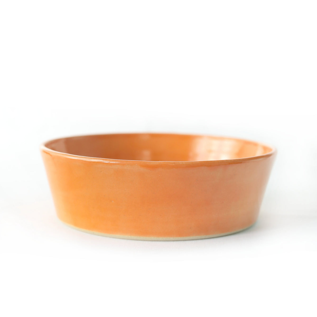 Mandarin orange ceramic pasta bowl by Katie L Thompson Designs with vibrant orange and white patterns.