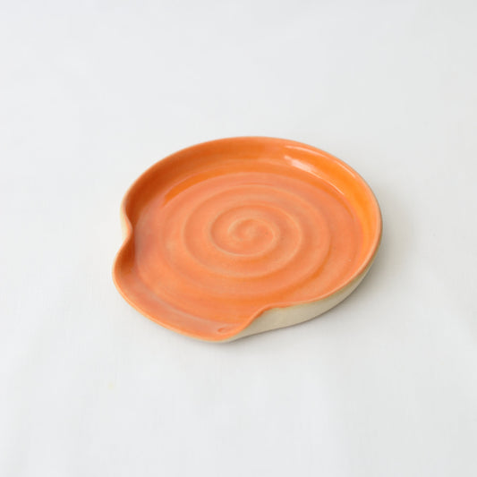 Mandarin orange-shaped spoon rest by Katie L Thompson Designs, ceramic kitchen accessory for holding cooking spoons.