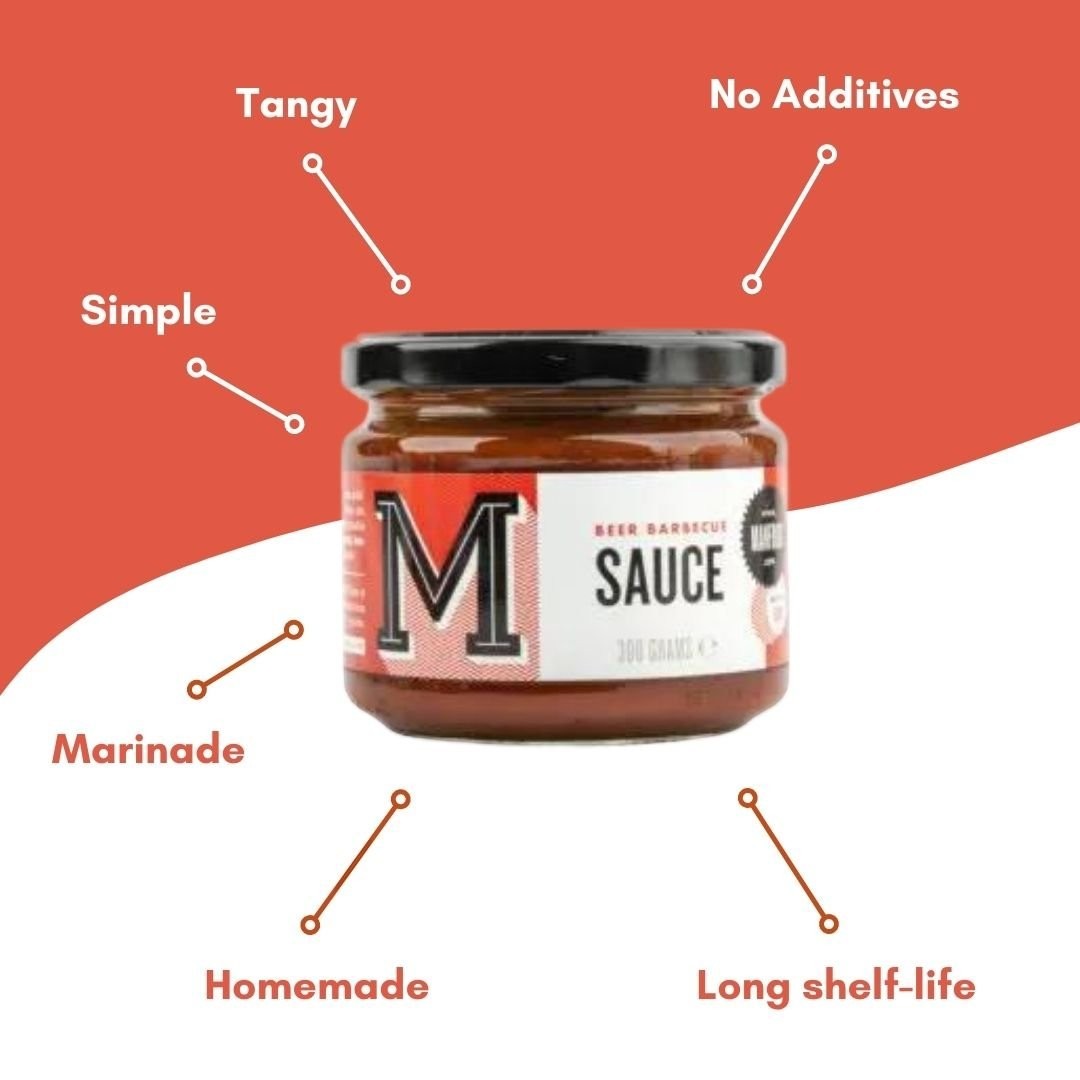 Manfood Beer Barbecue Sauce bottle with label, showcasing rich, dark sauce in a squeeze bottle on a wooden surface.