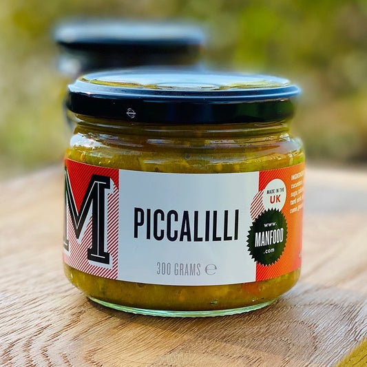 Jar of Manfood Chunky Piccalilli, a crisp vegetable relish with colorful chopped vegetables in a glass jar.