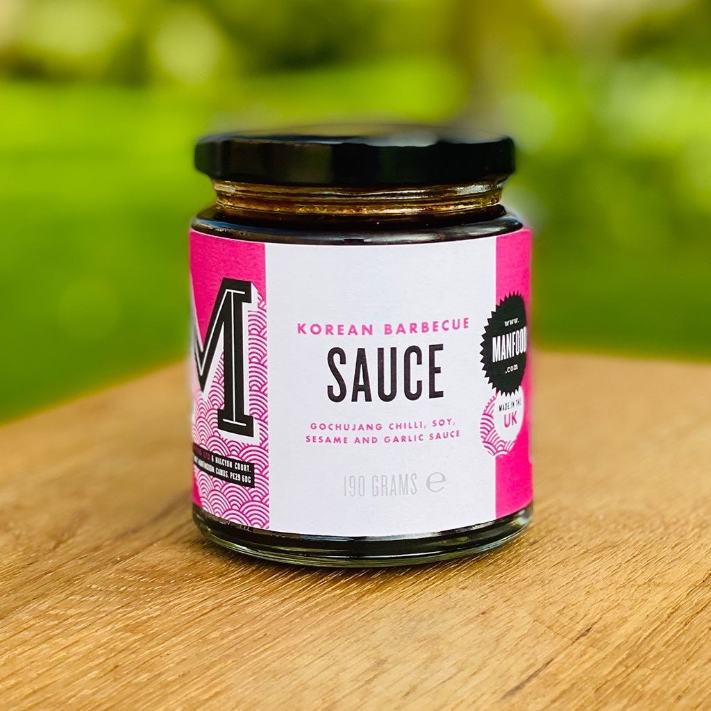 Manfood Korean BBQ sauce in a glass bottle, showcasing the rich, dark-colored sauce with a label featuring Korean cuisine imagery.