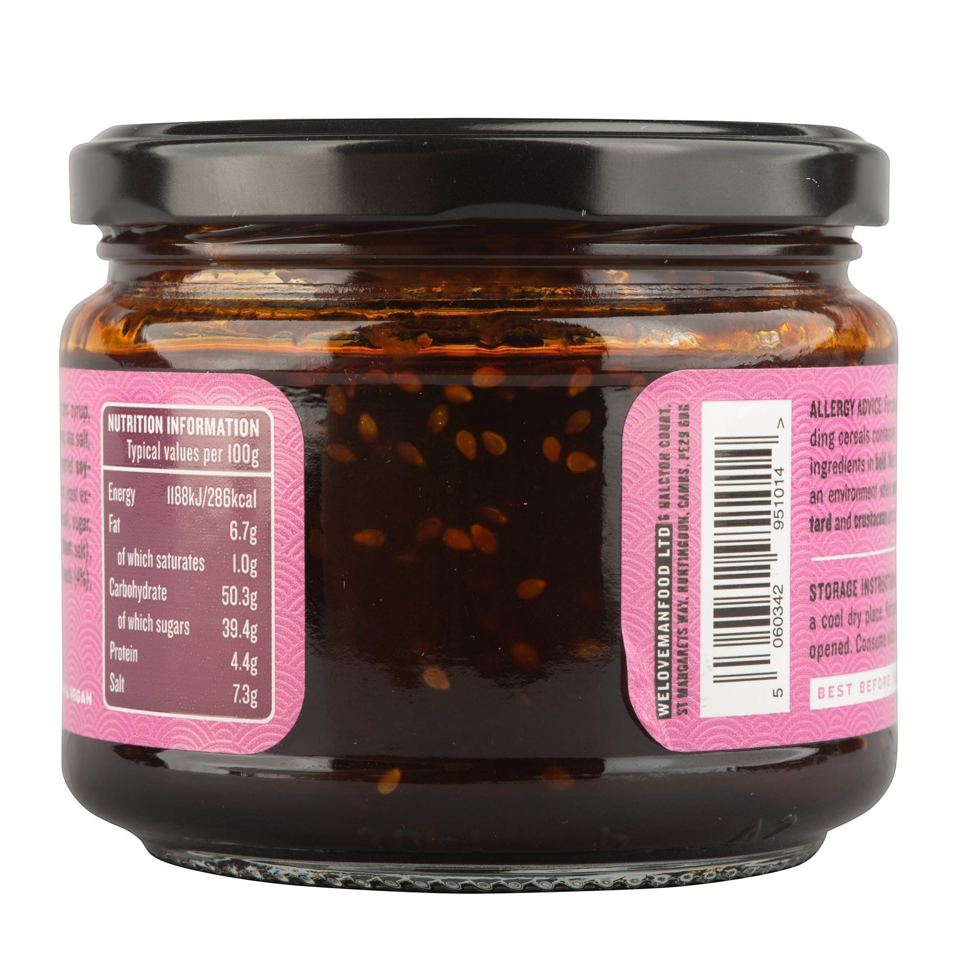 Manfood Korean Taco Sauce in a glass jar with a black lid, showing nutrition label and sesame seed texture.
