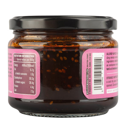 Manfood Korean Taco Sauce in a glass jar with a black lid, showing nutrition label and sesame seed texture.