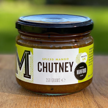Jar of Manfood Spiced Mango Chutney with visible orange mango chunks and spices, served in a glass jar.