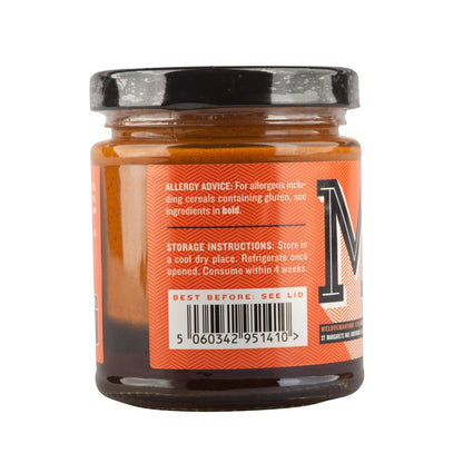 Manfood vegan buffalo sauce bottle with chili, onion, and butter flavor label showing the spicy sauce inside.