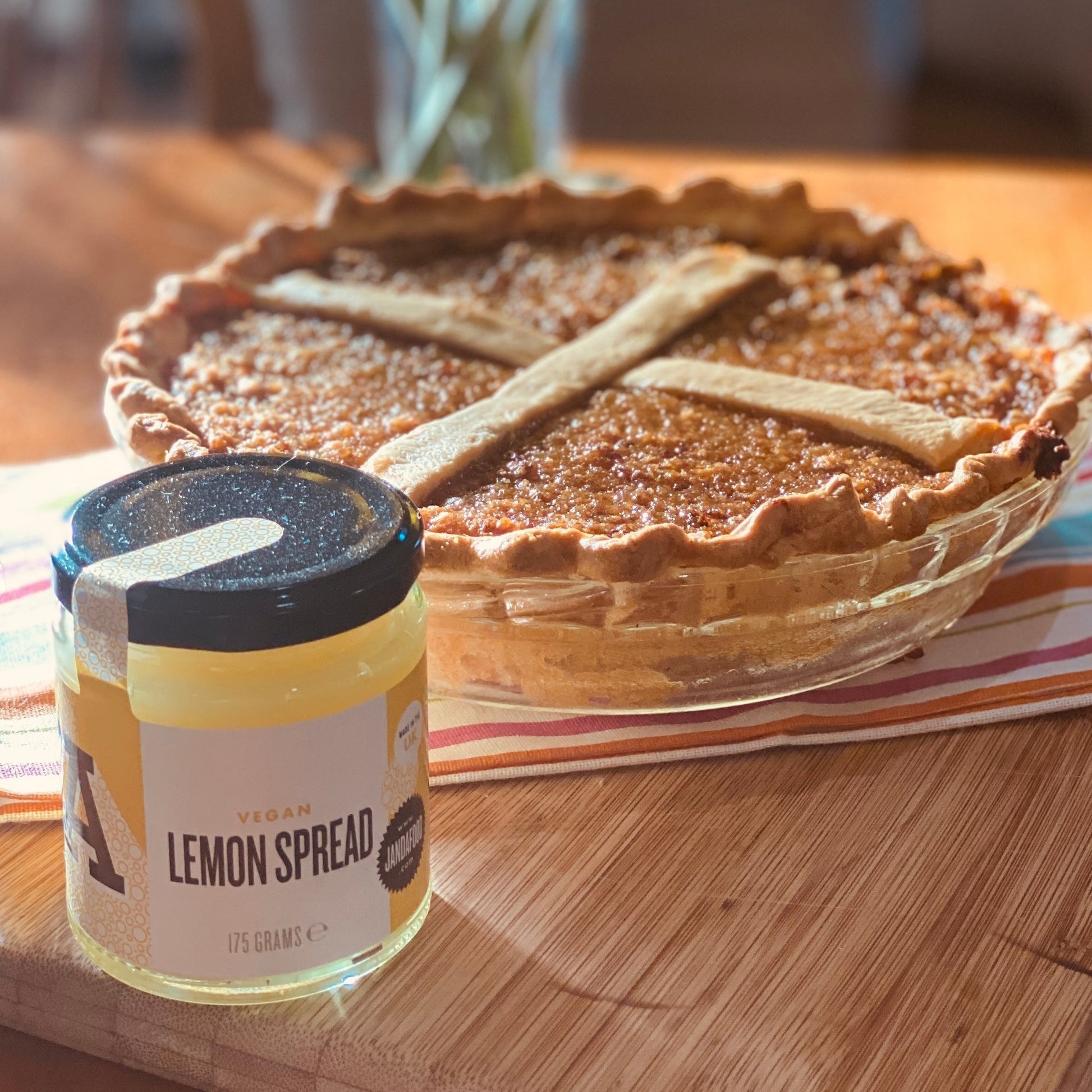 Jar of Manfood vegan lemon curd spread with a bright yellow lemon on the label, showcasing a smooth, vibrant citrus spread.