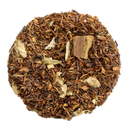 PekoeTea Edinburgh Chai Rooibos tea in a cup, featuring reddish-brown rooibos tea with spices and fresh ingredients.