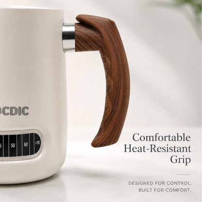 KNOCDIC® milk frothing pitcher with handle and built-in thermometer for perfect steamed milk and latte art preparation.