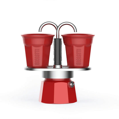 Red Bialetti Mini Express double serve espresso maker with two cups, compact Bialetti hardware for office or home use