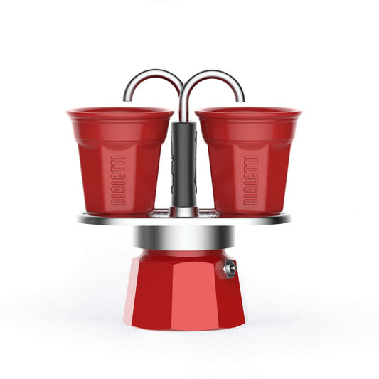 Red Bialetti Mini Express double serve espresso maker with two cups, compact Bialetti hardware for office or home use