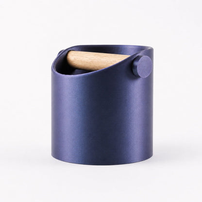 Minimalist coffee knock box with a sleek design and real oak wood bar, featuring a galaxy nebulae background.