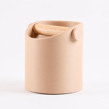 Minimalist KNOCDIC® coffee knock box with latte brown finish and real oak wood bar for espresso grounds disposal.
