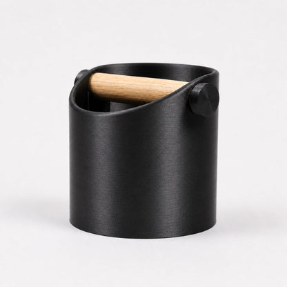 Black metallic minimalist coffee knock box with real oak wood bar from KNOCDIC® for espresso machine cleaning and coffee accessories.