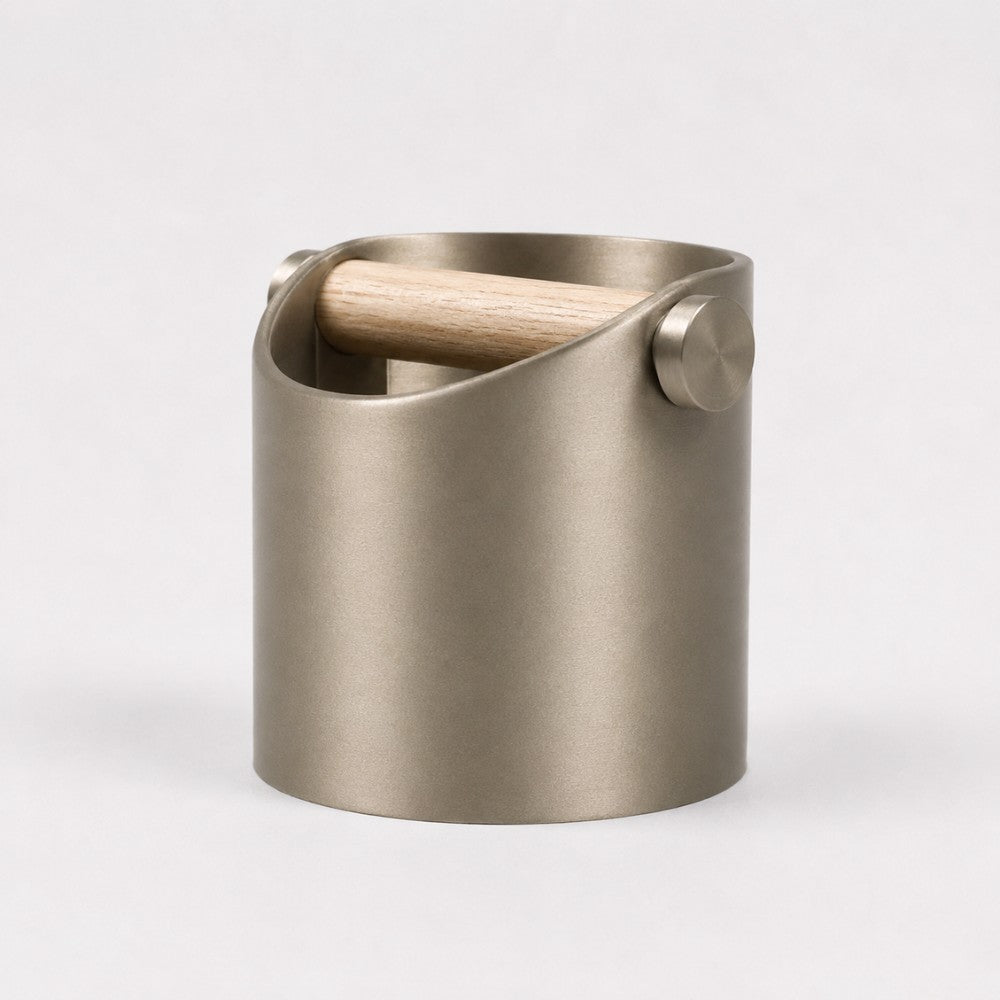KNOCDIC® minimalist coffee knock box with metallic gold finish and real oak wood bar for espresso machine portafilter cleaning.