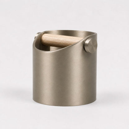 KNOCDIC® minimalist coffee knock box with metallic gold finish and real oak wood bar for espresso machine portafilter cleaning.