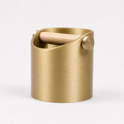 Gold metallic KNOCDIC® minimalist coffee knock box with a real oak wood bar, sleek and modern design for espresso prep.