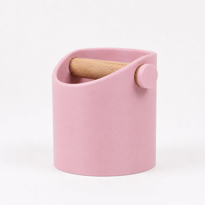 Pink minimalist coffee knock box with a real oak wood bar, designed by KNOCDIC® for easy espresso puck disposal.