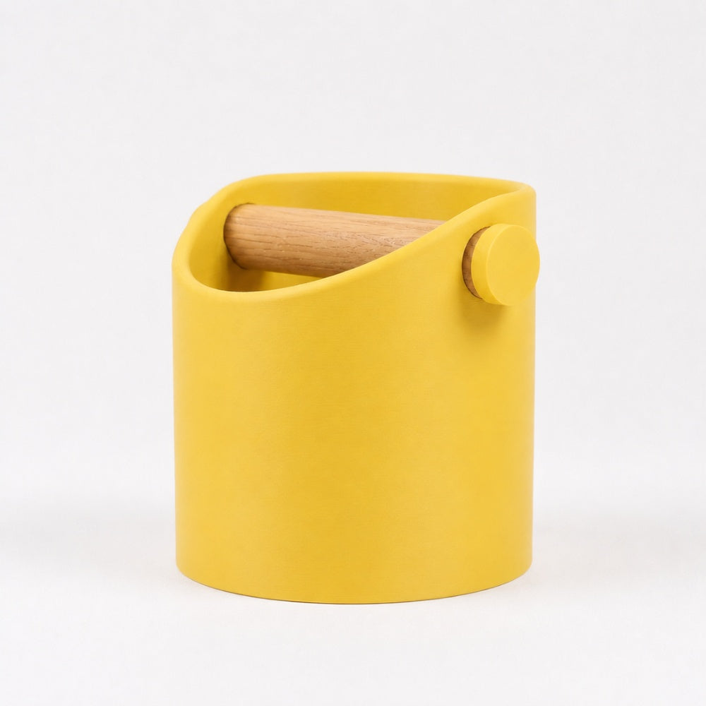 KNOCDIC® minimalist coffee knock box with yellow finish and real oak wood bar for espresso puck disposal.