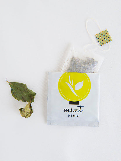 Fresh bundle of Mint of Crete tea bags by The Greek Deli Club, showing vibrant mint leaves on packaging.