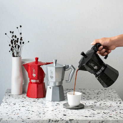 Bialetti Moka Express Exclusive coffee maker with sleek black finish and stainless steel handle, designed for stovetop brewing.