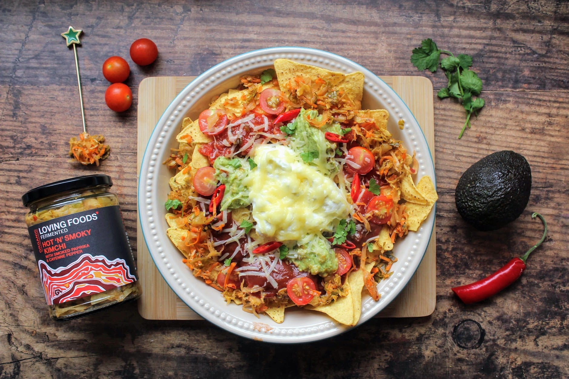 Spicy hot and smoky organic kimchi from Loving Foods served on crispy nachos with visible kimchi pieces and vibrant toppings.