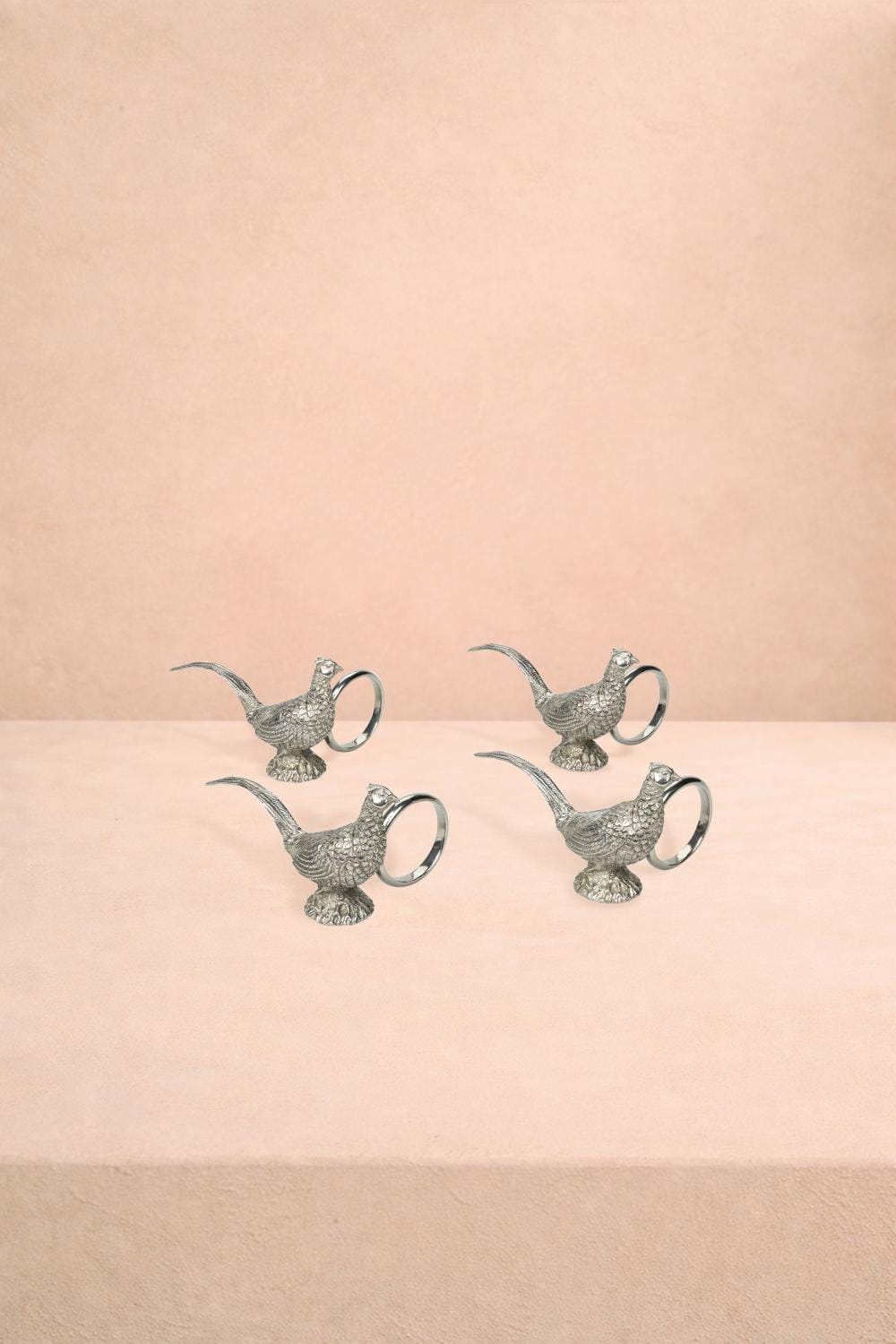 Set of four pewter napkin rings featuring pheasant feather design by Casa by Josephine Jenno for elegant table settings.