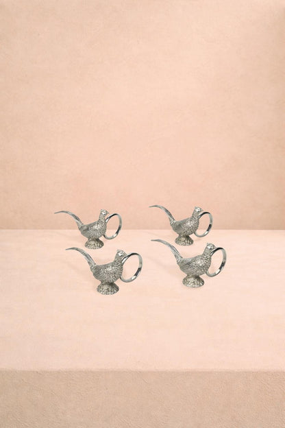 Set of four pewter napkin rings featuring pheasant feather design by Casa by Josephine Jenno for elegant table settings.