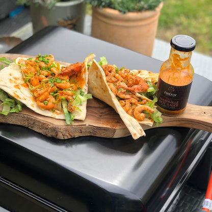 Juicy prawns topped with Nashville Hot Sauce from FireFly Barbecue, showcasing a spicy BBQ seafood dish.