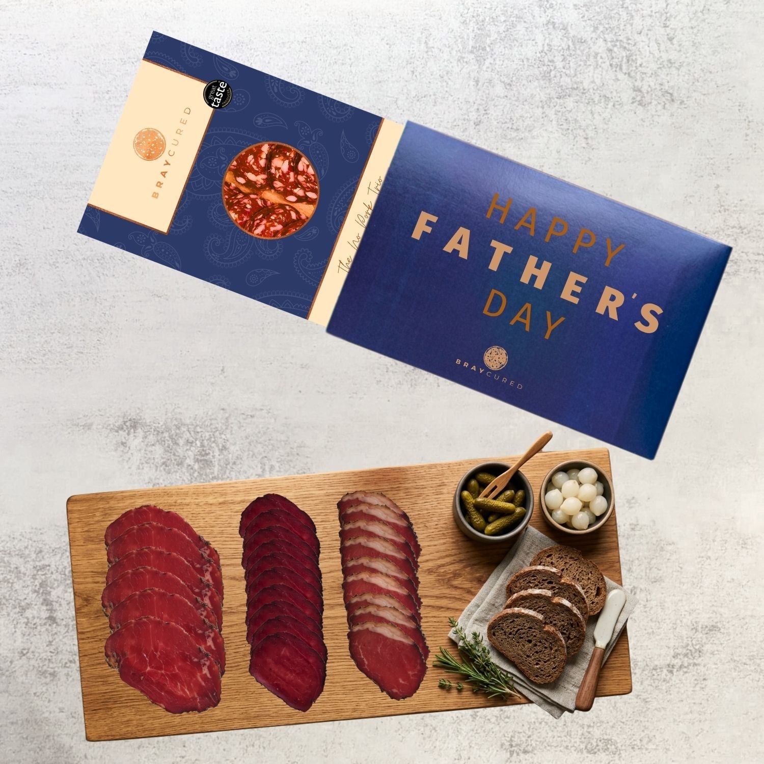 No Pork Tasting Trio charcuterie selection by Bray Cured on a wooden board with a Father’s Day sleeve.