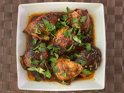 Filipino Adobo Sauce from RoniBs Kitchen in a glass jar, showcasing rich, dark Filipino-style condiment for flavorful dishes.