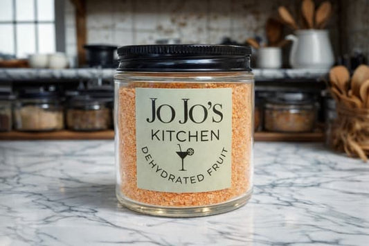 Bright orange powder in a bowl, natural orange powder from JoJo’s Kitchen, close-up of vibrant, finely ground orange seasoning or spice.