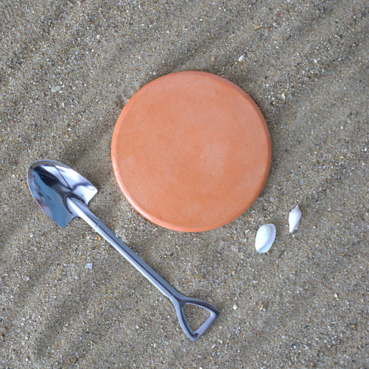 Flat lay of a square ceramic coaster featuring a vibrant mandarin orange design by Katie L Thompson Designs.